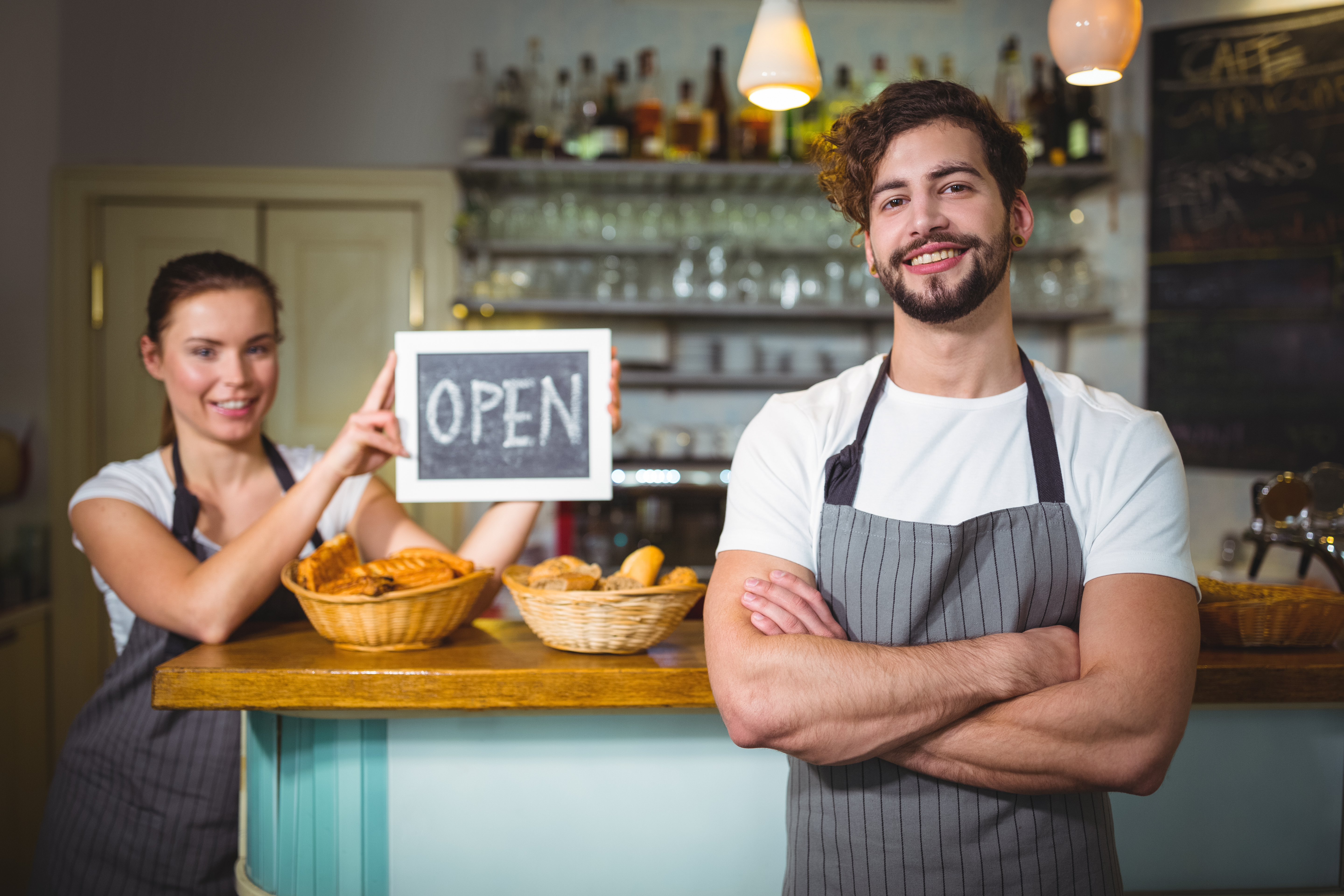 waiter-standing-with-arms-crossed-counter-cafa-c.jpeg