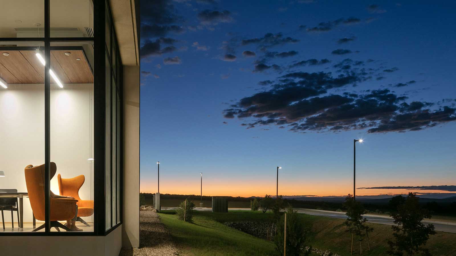 UNM Taos campus at night with logo overlayed